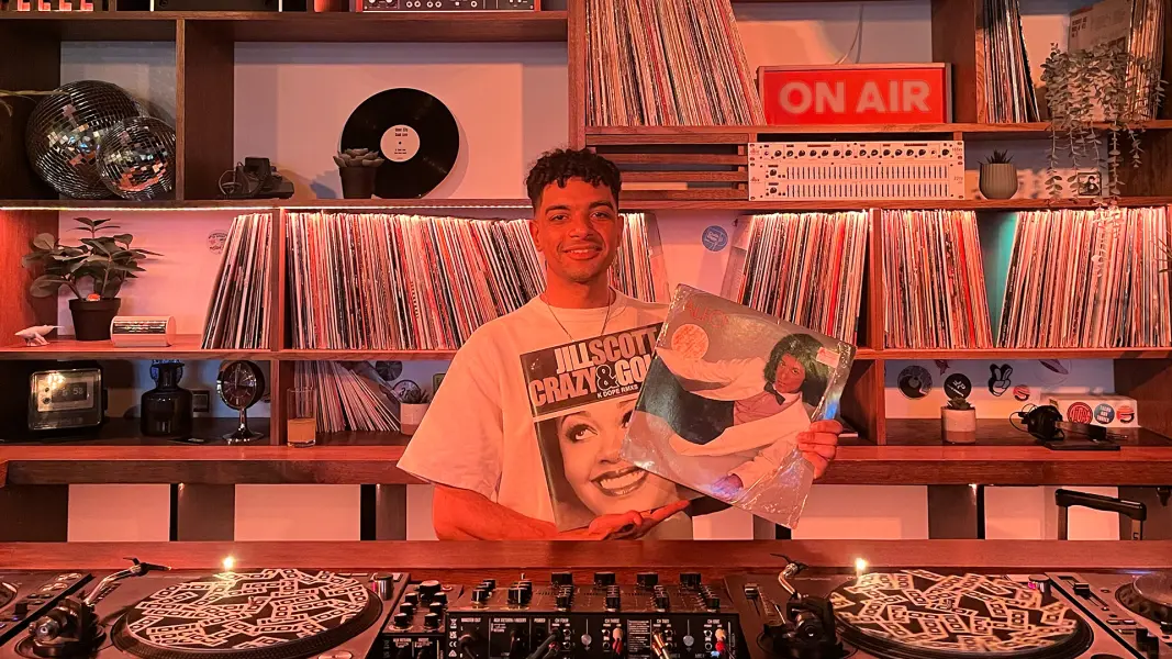 Kirollus DJ performing at Cafe 1001 custom vinyl DJ booth and rotary mixer