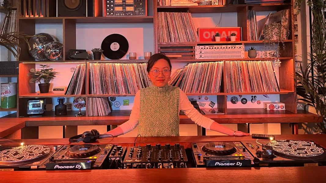 Stella Z DJ performing at Cafe 1001 custom vinyl DJ booth and rotary mixer