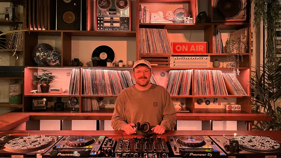 fungi DJ performing at Cafe 1001 custom vinyl DJ booth and rotary mixer